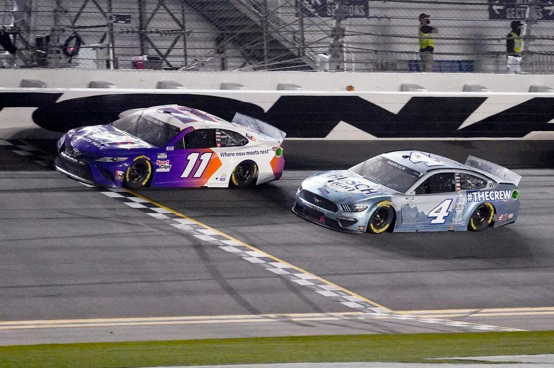 Denny Hamlin wins the second stage ahead of Kevin Harvick during the NASCAR Daytona 500 auto race at Daytona International Speedway, Sunday, Feb. 14, 2021, in Daytona Beach, Fla. (AP Photo/John Raoux)