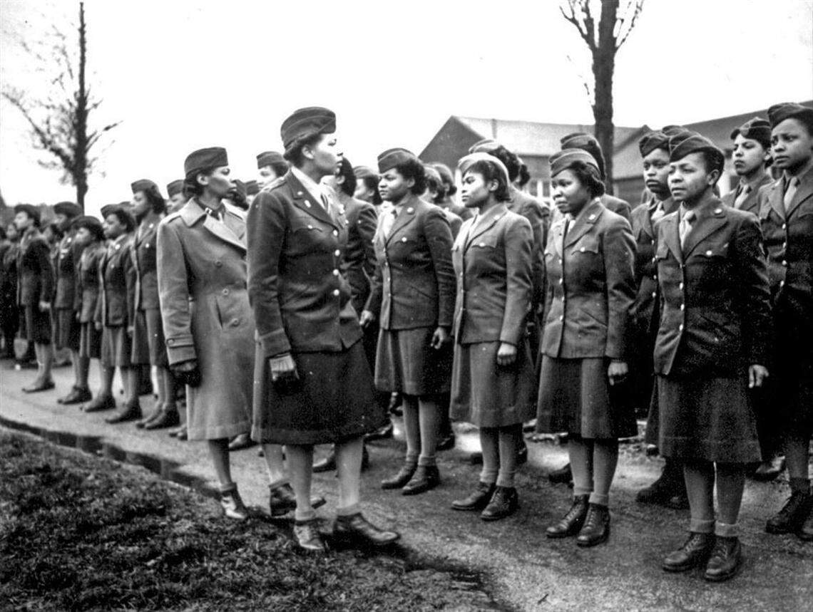 Women’s Army Corps Maj. Charity Adams, center, inspect the first soldiers from the 6888th Central Postal Directory Battalion to arrive in England in February 1945.