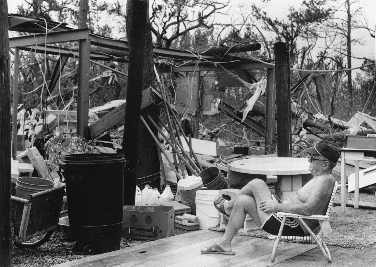 9.29.1989: B.L. Jeffcoat sits on his make shift porch staring into his former home at Whitehall Terrace. staff photo by Jeff Siner