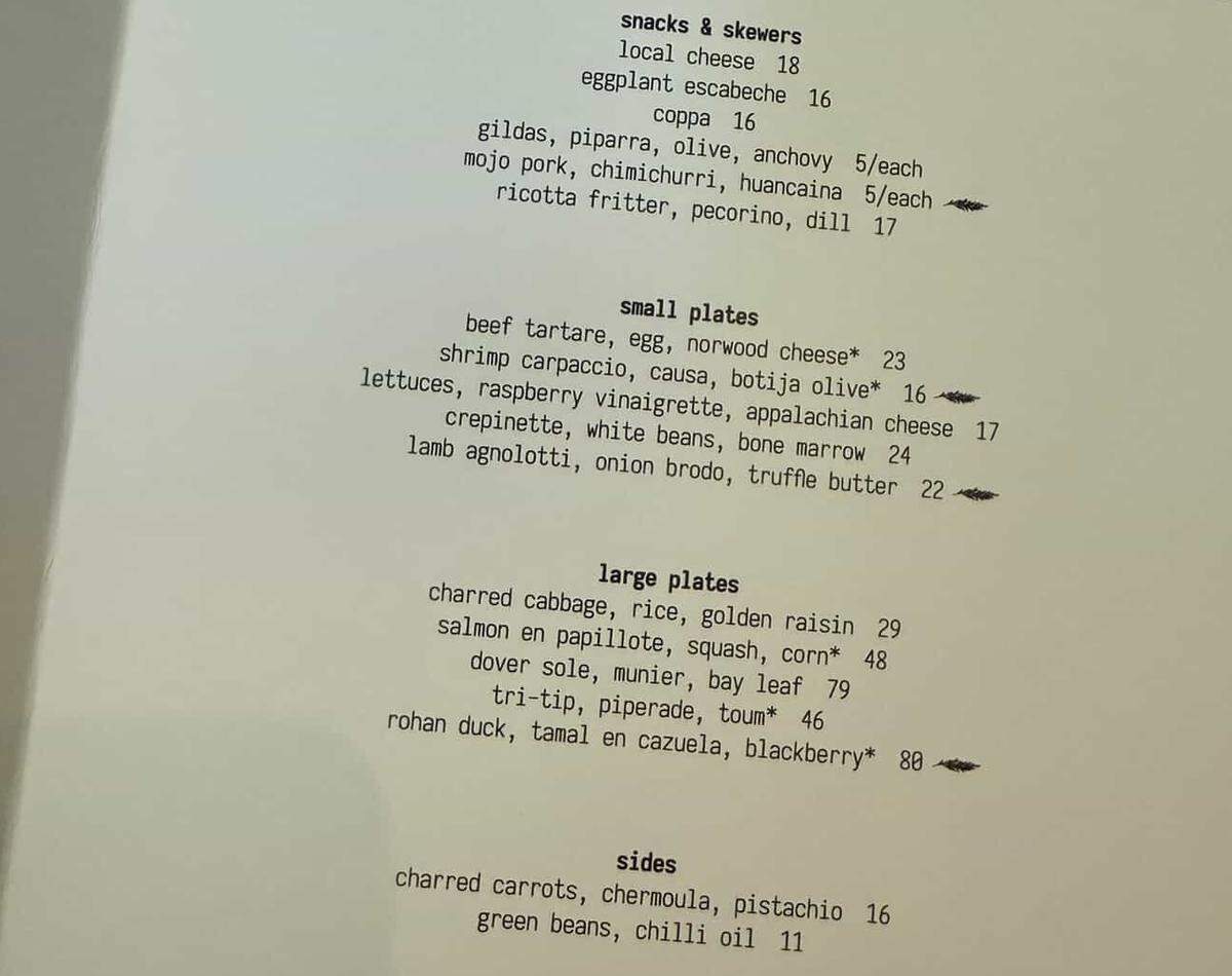 The printed à la carte menu for the Rada and Customshop collaboration, showing sections for snacks, small plates, large plates, and sides. Dishes include beef tartare, lamb agnolotti, dover sole and rohan duck.