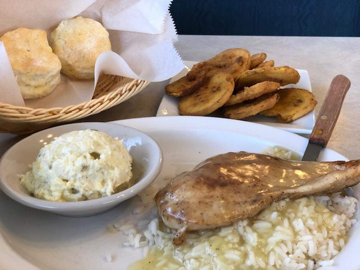 Marinated chicken breast served over rice and gravy with potato salad, fried squash and a biscut at Gus’ Sir Beef.