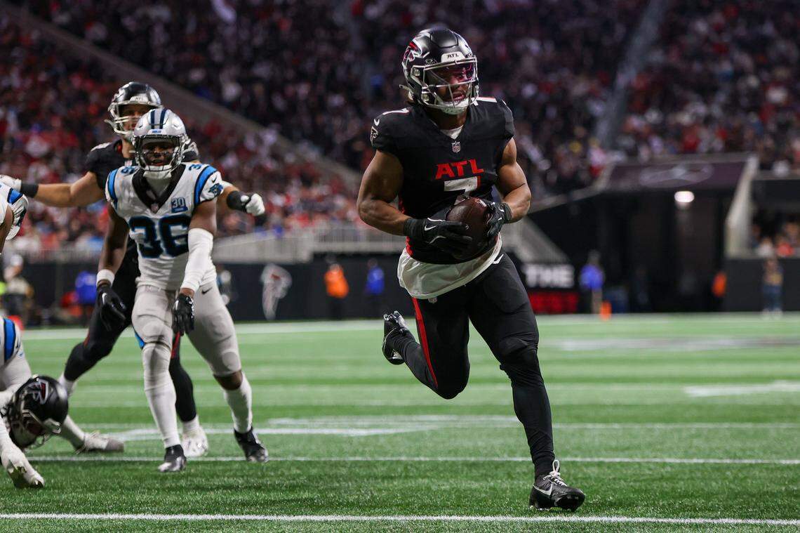 Jan 5, 2025; Atlanta, Georgia, USA; Atlanta Falcons running back Bijan Robinson (7) runs the ball for a touchdown against the Carolina Panthers in the second quarter at Mercedes-Benz Stadium. Mandatory Credit: Brett Davis-Imagn Images