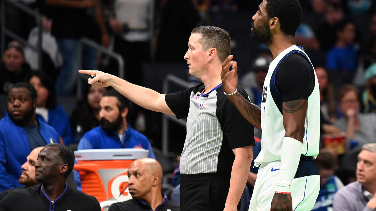 An official points to security to have a fan ejected with Dallas Mavericks guard Kyrie Irving during second half action at Spectrum Center in Charlotte, NC on Sunday, March 26, 2023. The Charlotte Hornets defeated the Dallas Mavericks 110-104.