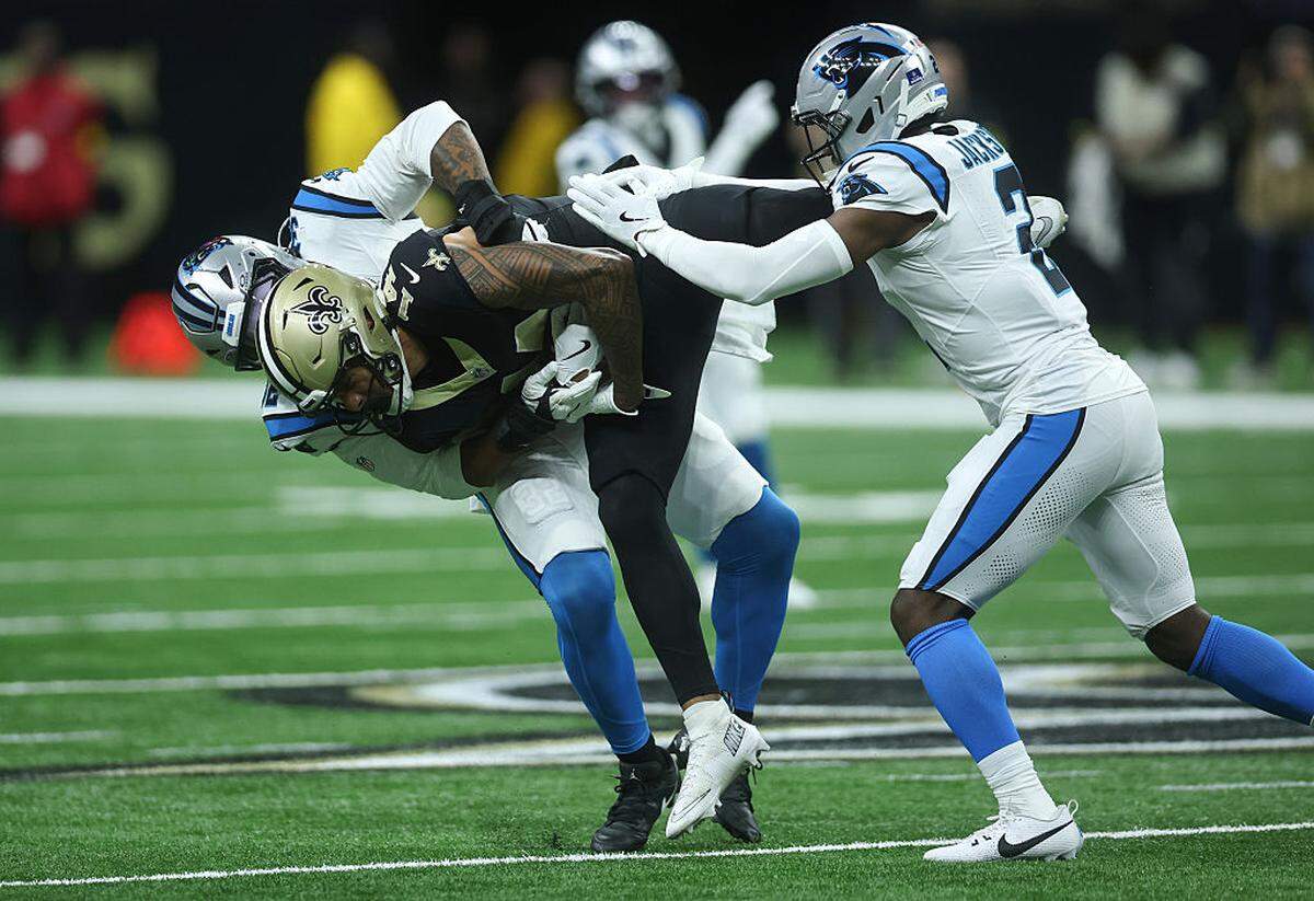 Carolina Panthers linebacker Trevin Wallace (32) tackles Devaughn Vele (14) of the New Orleans Saints during Sunday’s second quarter at Caesars Superdome.