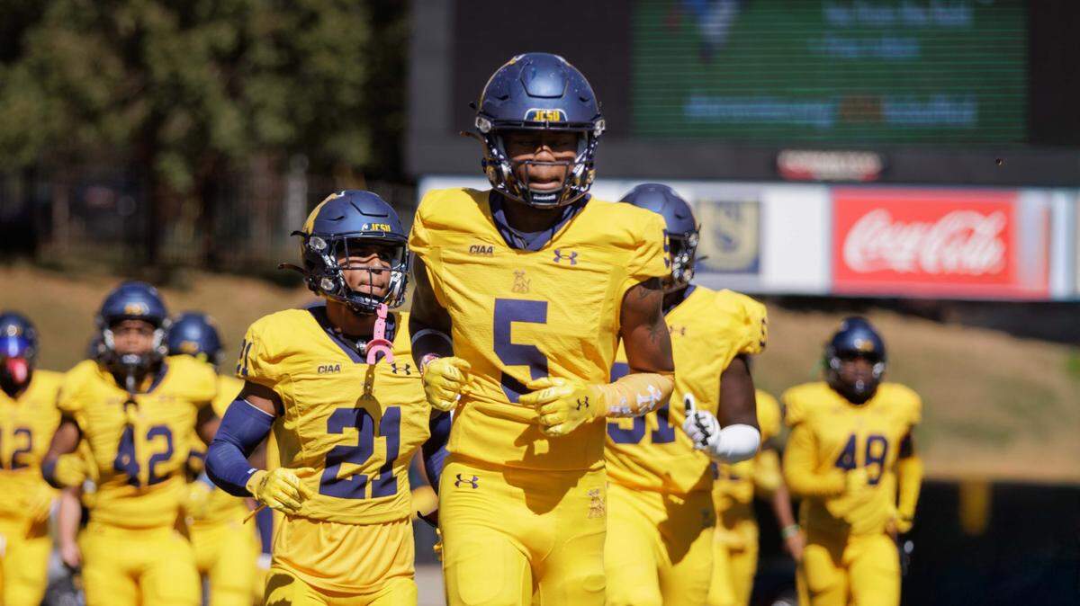 Johnson C. Smith players run onto their home field for their homecoming game on Oct. 19, 2024. The Golden Bulls won that game and finished 8-2 this season. On Sunday, they will find out if they make the Division II football playoffs.