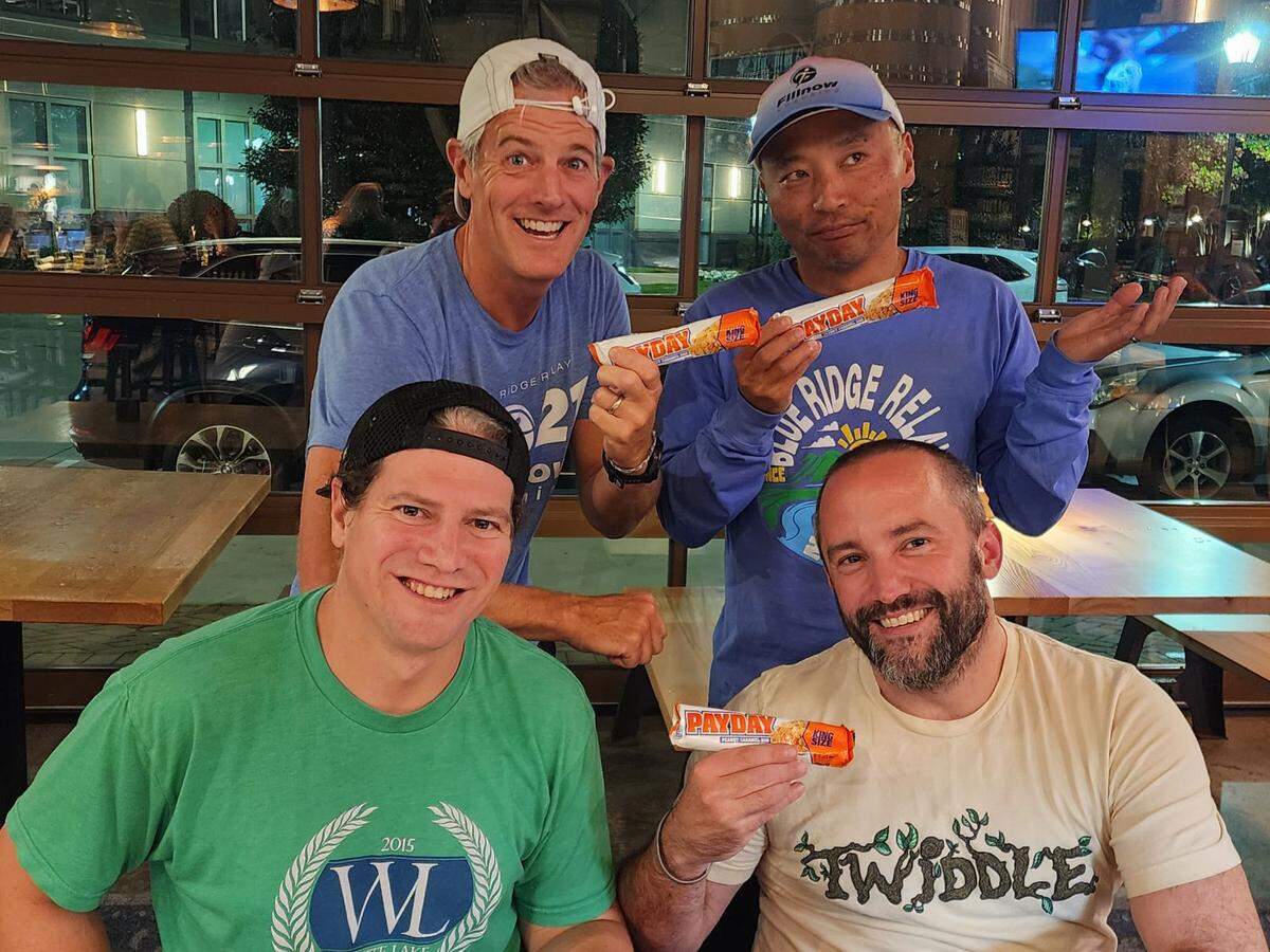 Théoden Janes, upper right, after signing up for Ironman California with friends — including Chuck, lower right, who is smiling but not happy about it.