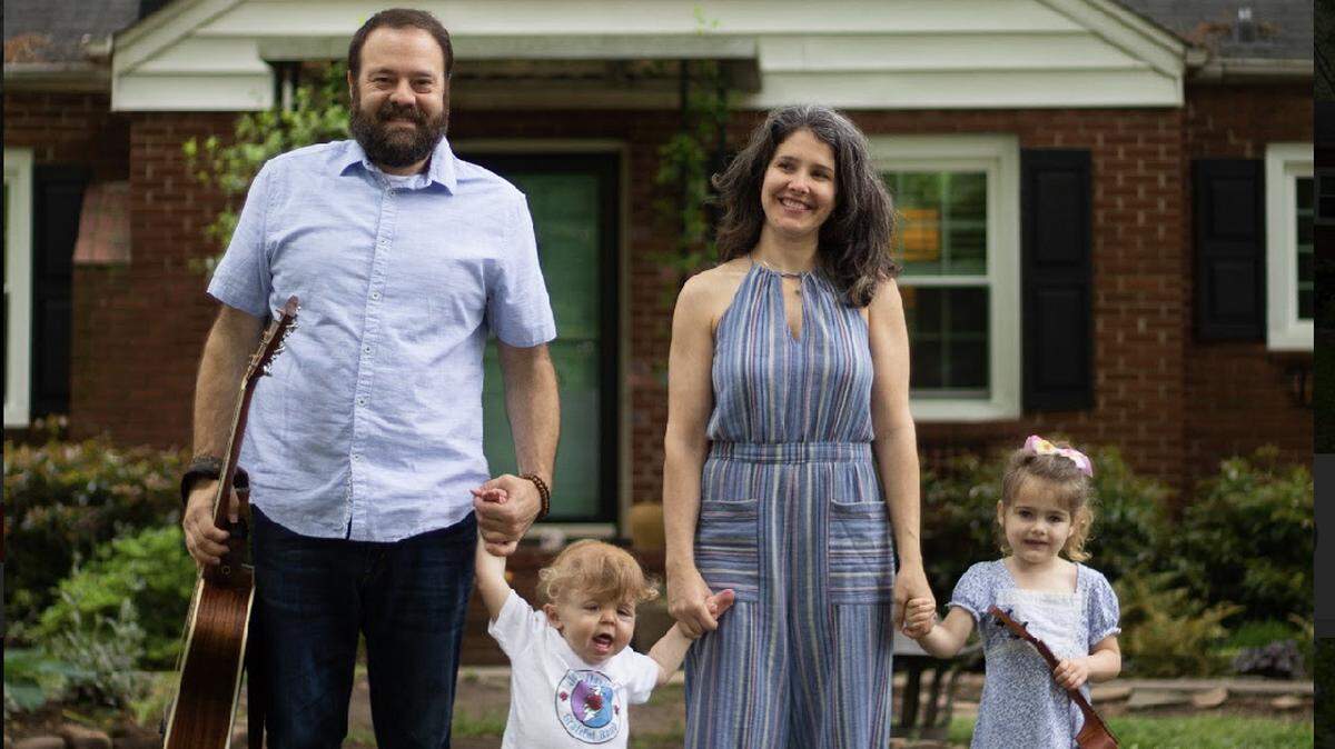 From left: Josh Daniel with son Sonny, wife Kellie and daughter Maddie, in front of their Plaza-Shamrock home — where Daniel is playing music on Facebook Live daily.
