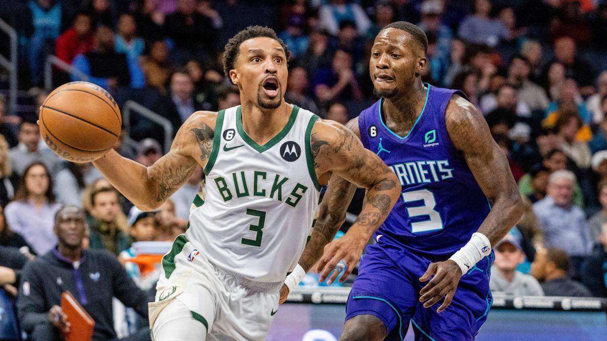 Milwaukee Bucks guard George Hill, left, drives past Charlotte Hornets guard Terry Rozier during the first half of an NBA basketball game Saturday, Dec. 3, 2022, in Charlotte, N.C. (AP Photo/Scott Kinser)