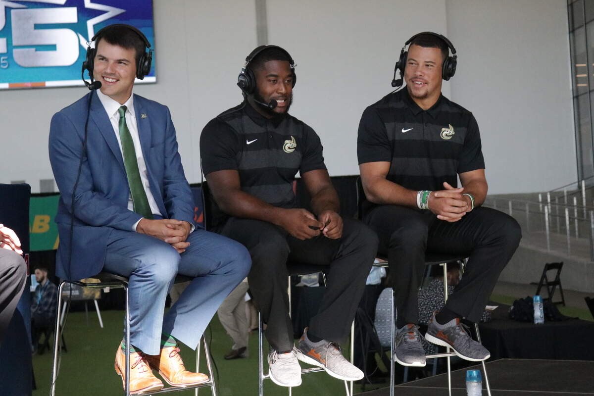 Charlotte 49ers players Benny LeMay (center) and Alex Highsmith (right) share the stage with first-year coach Will Healy during Conference USA’s media day in Frisco, Texas, on Thursday.
