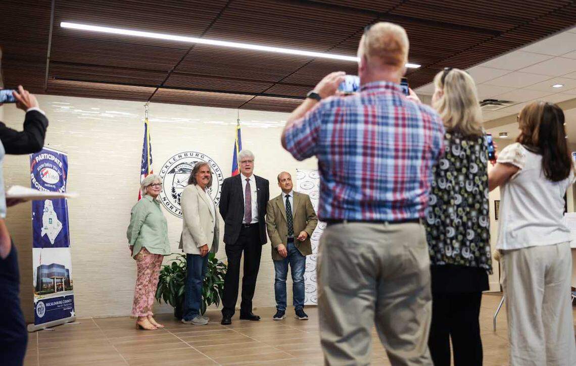 Supporters take photos of a group of Matthews candidates at Mecklenburg County town elections Monday, July 7, 2025.
