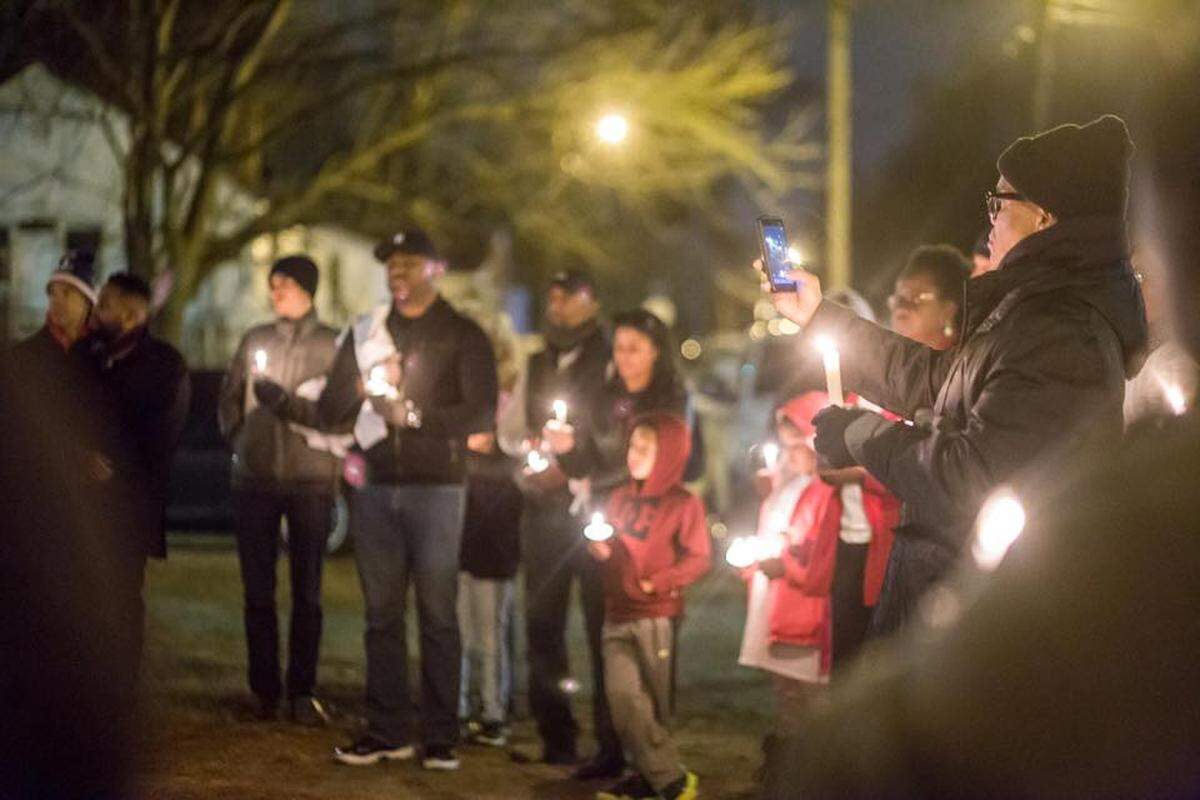 Residents take part in a candelight peace vigil in Durham. The vigil was organized by Bull City United, a violence interruption program.