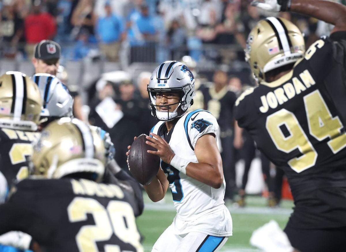 Carolina Panthers quarterback Bryce Young, center, stands in the pocket looking to pass as the New Orleans Saints defense rushes during late fourth-quarter action at Bank of America Stadium on Monday, September 18, 2023. The Saints defeated the Panthers 20-17.