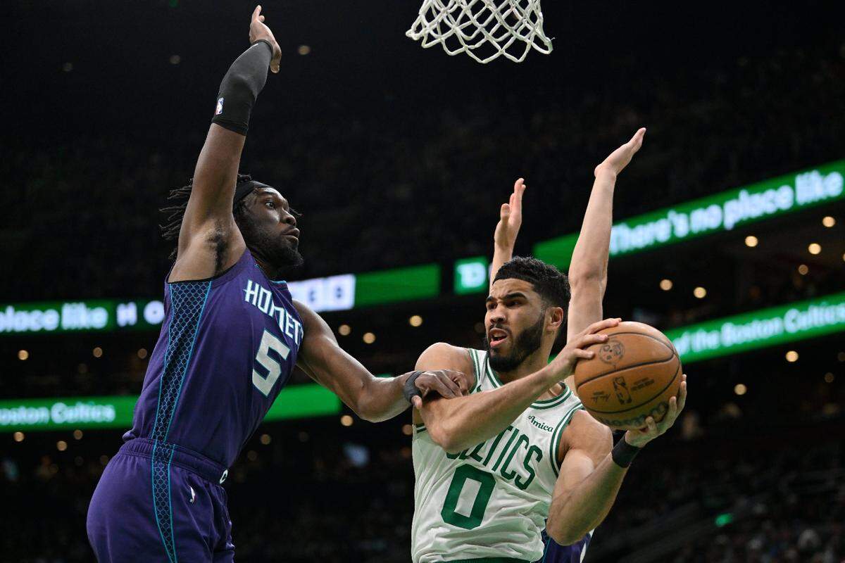 Boston Celtics forward Jayson Tatum (0) passes the ball against Charlotte Hornets center Mark Williams (5) during the first half at TD Garden.
