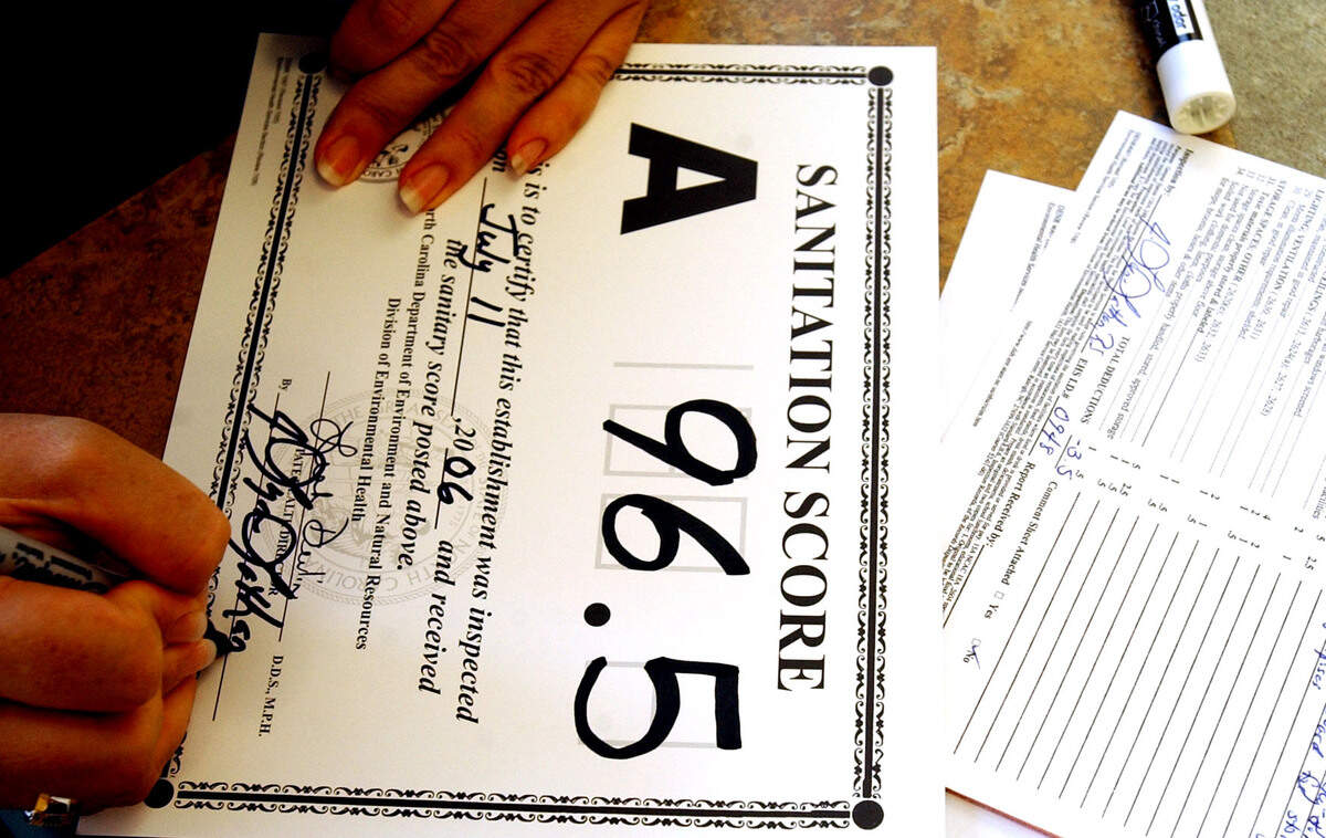 Lynn Lathan, Environmental Health Supervisor of the Mecklenburg County Health Department, signs her name to a sanitation score after conducting  an inspection of the Subway restaurant in the Park Road shopping center in Charlotte.