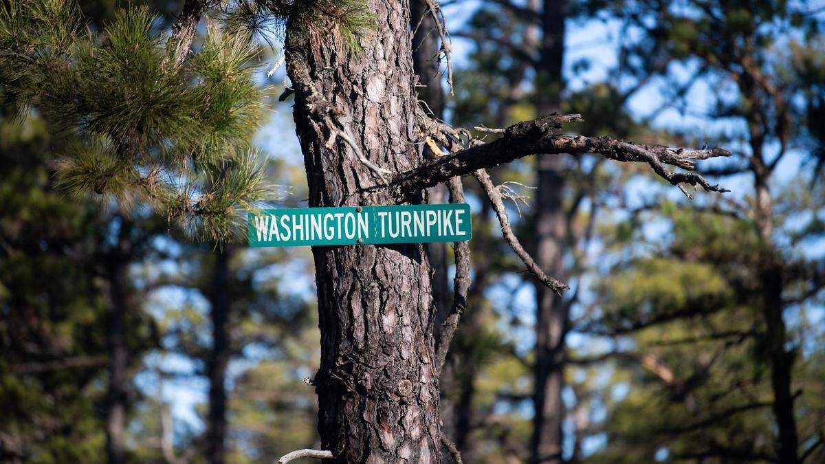 A sign is posted on Washington Turnpike in the Pine Barrens, about 7 miles from the site where a pilot and a photographer for 6abc in Philadelphia were killed, the station reported Wednesday.