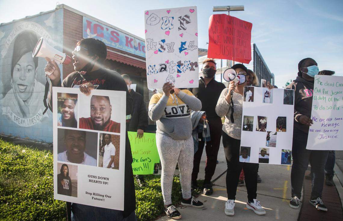 Lillian Owens, left, chants “guns down, hearts up” through a megaphone with a group of Durham residents impacted by the city’s gun violence on Saturday, November 14, 2020.