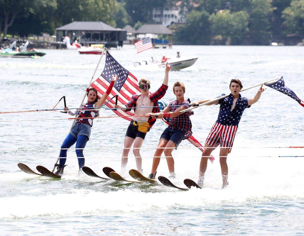 Performers with the Carolina Show Ski Team make a dramatic entrance at the Tega Cay 4th of July Celebration.