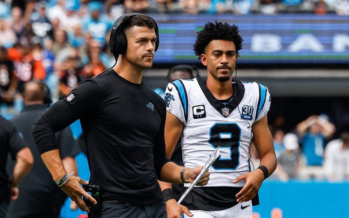 Panthers head coach Dave Canales, left, and quarterback Bryce Young stand on the field during a timeout during the game against the Bengals at Bank of America stadium in Charlotte, NC on Sunday, September 29, 2024.