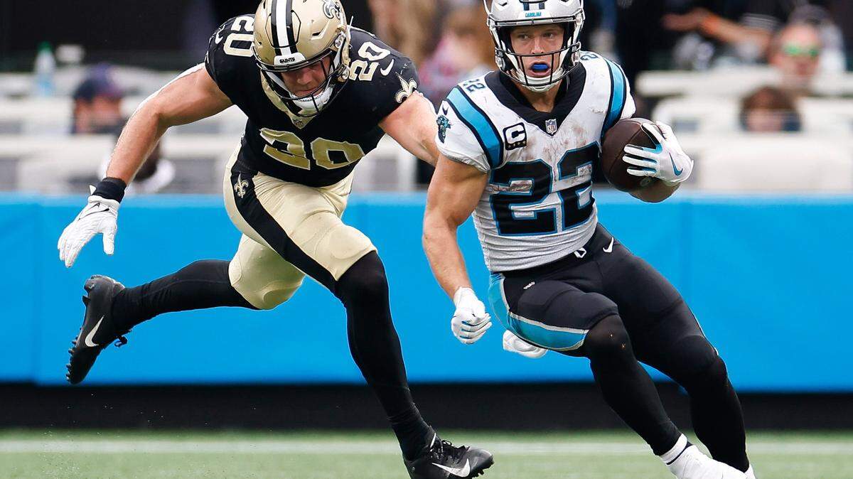 Carolina Panthers running back Christian McCaffrey (22) runs the ball past New Orleans Saints linebacker Pete Werner (20) during a game at Bank of America Stadium in Charlotte, N.C., Sunday, Sept. 25, 2022.