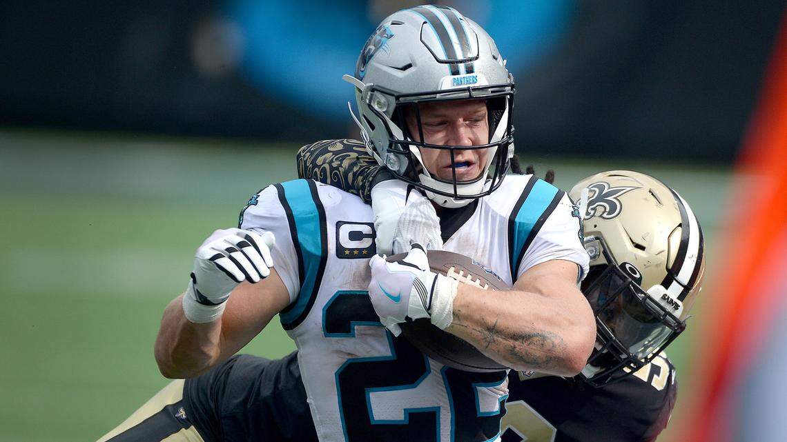 Carolina Panthers running back Christian McCaffrey fights for yardage as New Orleans Saints linebacker Demario Davis looks to make the tackle Sunday’s game at Bank of America Stadium in Charlotte.