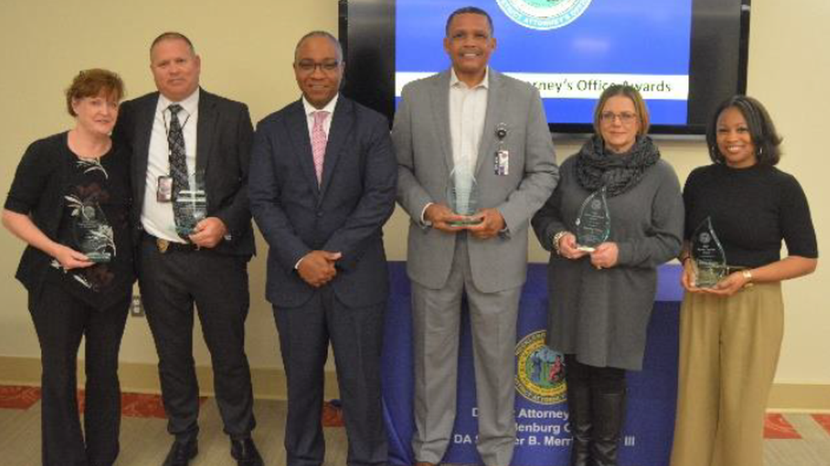 Mecklenburg District Attorney Spencer Merriweather presents awards to community leaders in December.