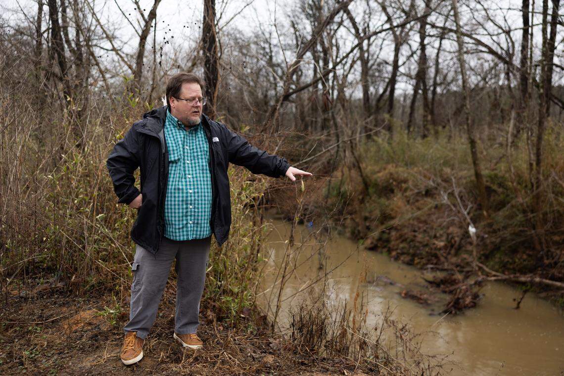 Brian Sikes, construction project manager for the upcoming Mallard Creek restoration project, points to issues the project will resolve along the creek in Charlotte, N.C., on Friday, February 27, 2026.