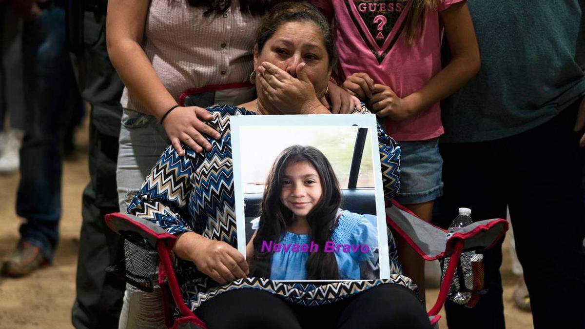Esmeralda Bravo, 63, sheds tears while holding a photo of her granddaughter, Nevaeh, one of 19 children killed in a mass shooting May 25, 2022 at Robb Elementary School in Uvalde, Texas. Two teachers also died.