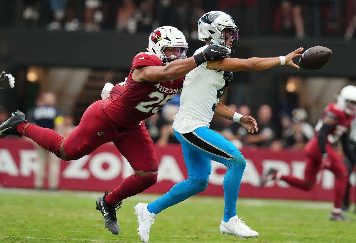 Arizona Cardinals linebacker Zaven Collins (25) dives after Carolina Panthers quarterback Bryce Young (9) as he pitches the ball at State Farm Stadium on Sept 14, 2025.
