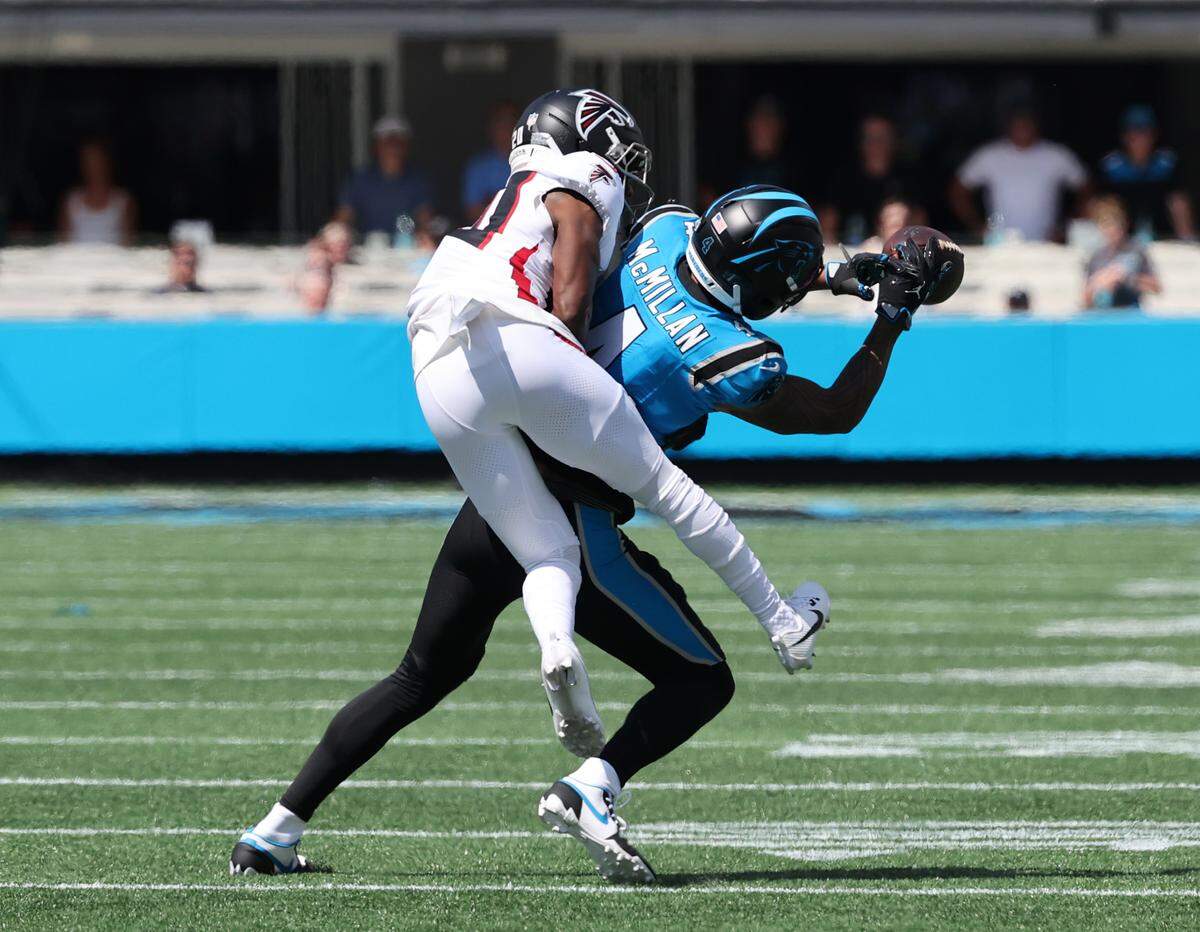 Panthers' Tetairoa McMillan catches the ball while being brought down by Falcons' Dee Alford on Sunday, Sept. 21, 2025, at Bank of America Stadium.