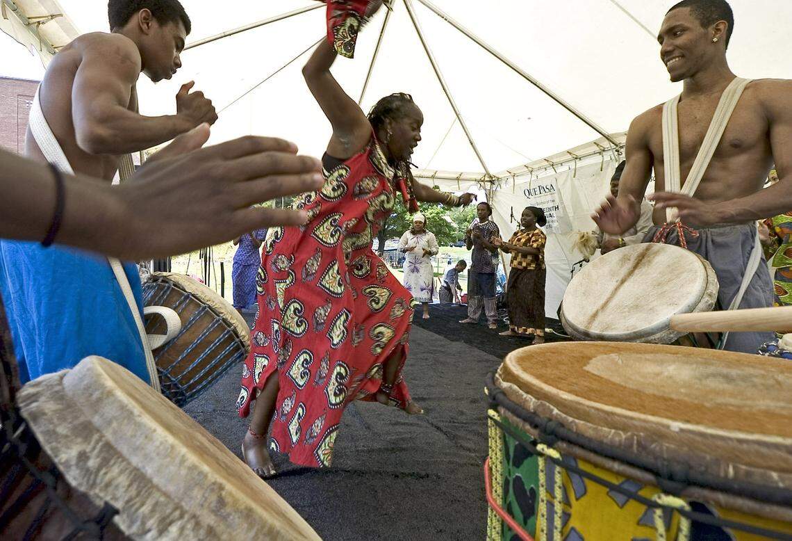 Faye Waklker, co-founder and artistic director of Virginia’s Ezibu Muntu African Dance Company, performs as other troupe members lay down a complex drum rhythm during a Juneteenth celebration at Independence Park in Charlotte, NC, on June 25, 2005. 