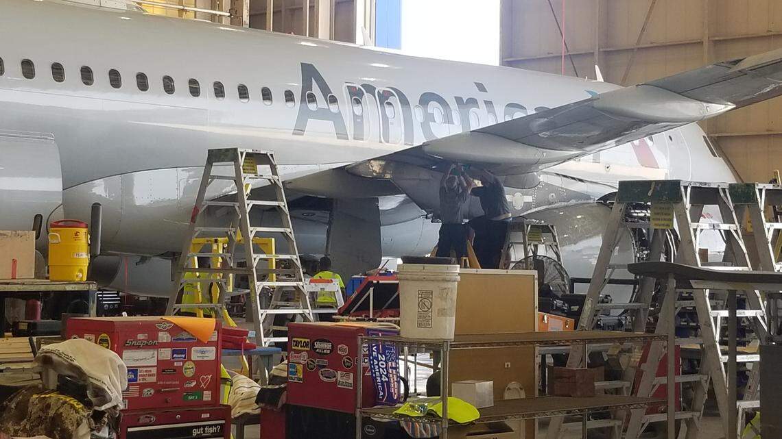 Aircraft maintenance technicians work on an American Airlines plane at Charlotte Douglas International Airport. The company is adding more than 100 AMT jobs for the Charlotte region.