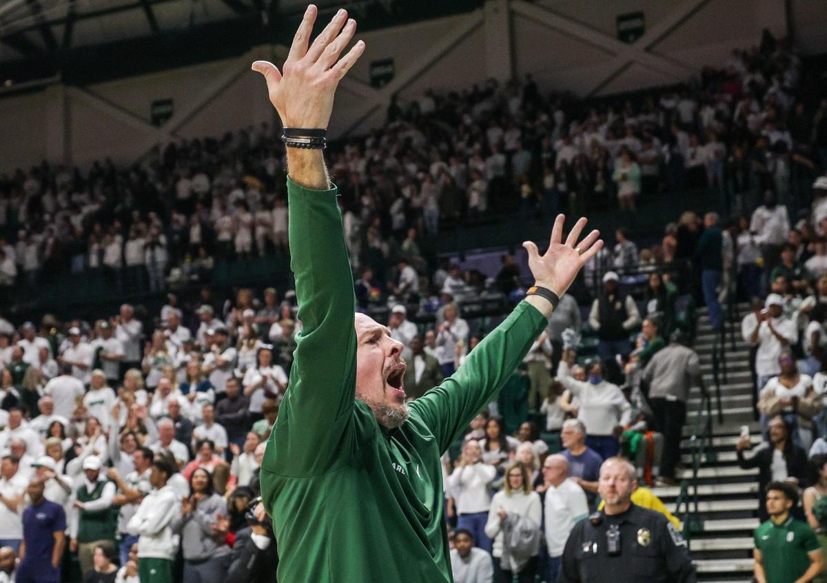 Charlotte 49ers head coach Aaron Fearne throws his arms up in celebration after a victory over the Pirates, 67-52, after the game at Halton Arena in Charlotte, NC, on Thursday, February 3, 2024. It was the 49ers’ eighth consecutive league win, a first in the team’s history.