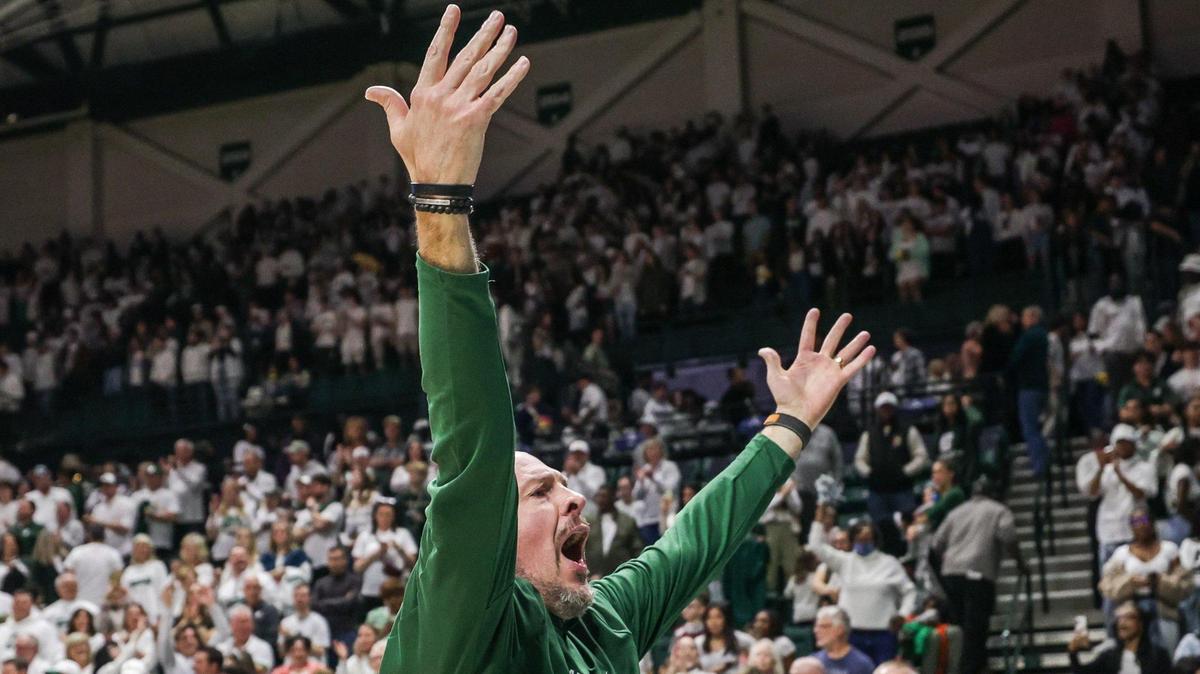Charlotte 49ers head coach Aaron Fearne throws his arms up in celebration after a victory over the East Carolina Pirates, 67-52, Saturday. It was Charlotte’s eighth consecutive win in conference play, which was a first in program history.