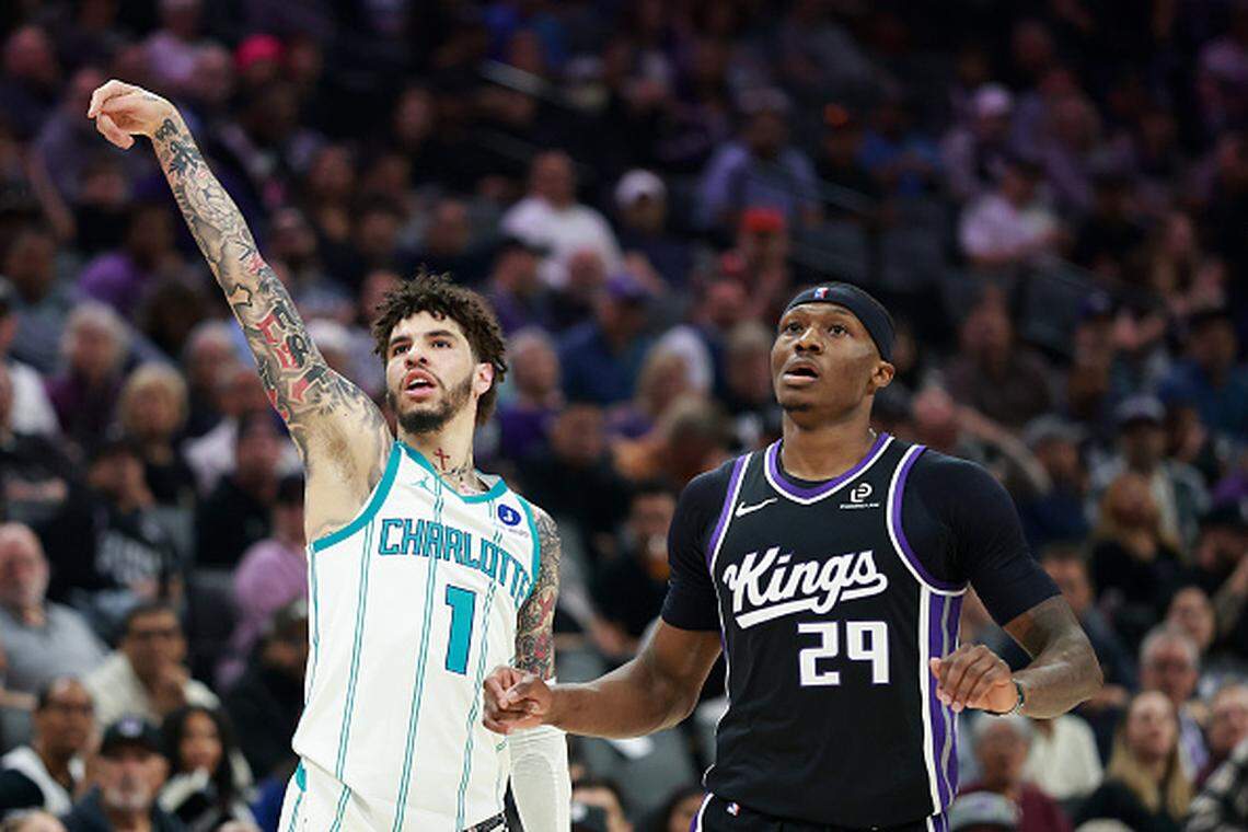 LaMelo Ball of the Charlotte Hornets and Daeqwon Plowden of the Sacramento Kings watch the ball after Ball’s shot during the first half at Golden 1 Center.