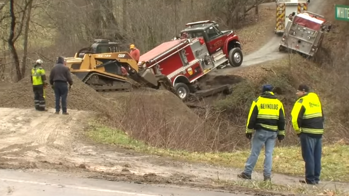 Fox Carolina video shows crews attempting to dig out a fire truck that was stuck Sunday after a bridge collapsed under it in Weaverville, N.C. Fox Carolina screen shot