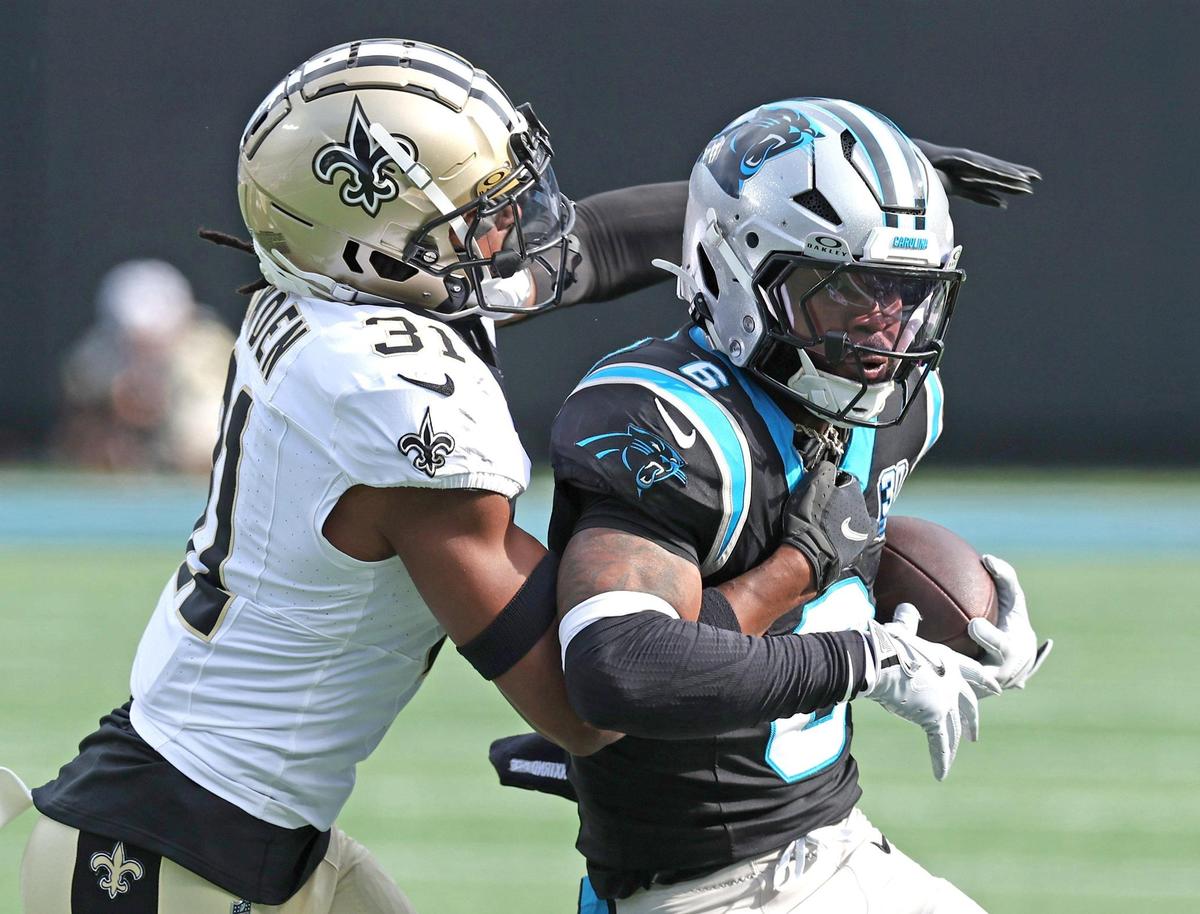 Carolina Panthers running back Miles Sanders, right, fight for yardage as New Orleans Saints defensive back Jordan Howden, left, looks to make the tackle at Bank of America Stadium in Charlotte, NC on Sunday, November 3, 2024. The Panthers defeated the Saints 23-22