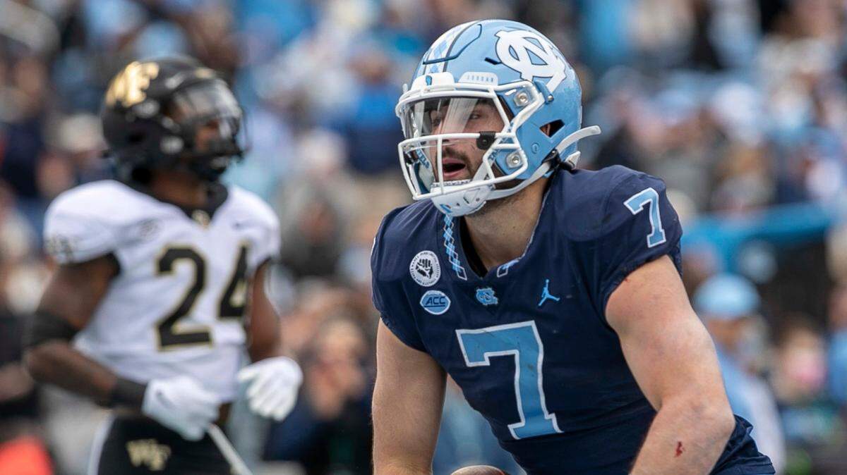North Carolina quarterback Sam Howell (7) knows he can’t survive in the NFL if he takes as many hits as he did in college.