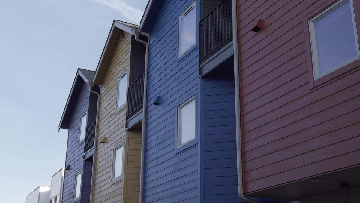 The 26 Columbia townhouses in Seattle’s Columbia City neighborhood are part of the Homestead Community Land Trust. The land trust model allows homeowners to buy at below-market rates, while the nonprofit land trust retains control of the land. It’s an affordable housing solution that proponents say promotes community wealth building and access to home ownership. Susan Zeman and Bob Downing bought their home in 2016 for one-third of the price of similar units nearby.