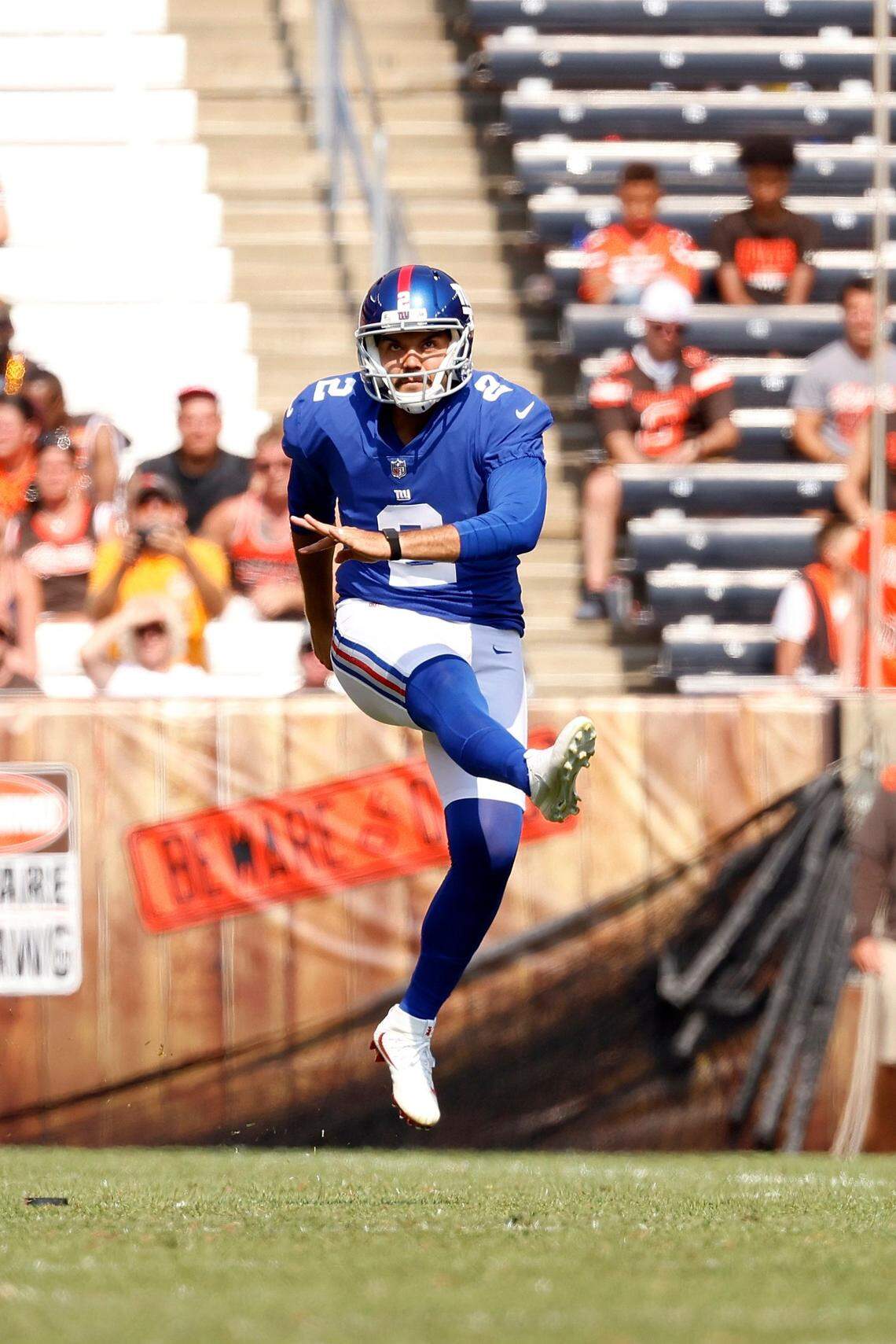 New York Giants punter Ryan Santoso (2) kicks the ball during an NFL football game against the Cleveland Browns, Sunday, Aug. 22, 2021, in Cleveland. (AP Photo/Kirk Irwin)