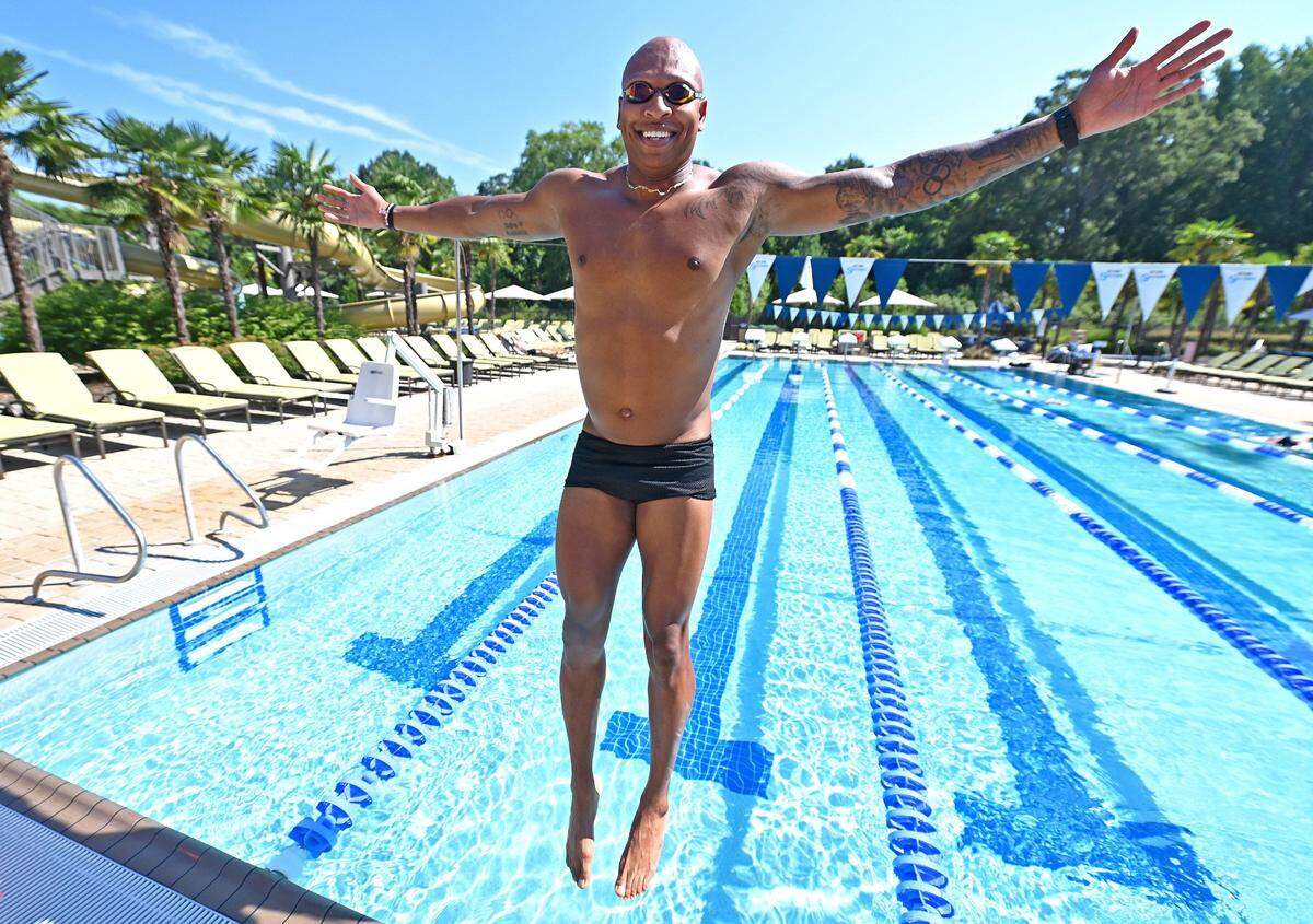 Former Olympic gold medalist swimmer Cullen Jones jumps into the Life Time outdoor pool on Wednesday, June 26, 2024. Jones earned two Olympic gold and two Olympic silver medals and represented Team USA in the Olympics in 2008 and 2012.