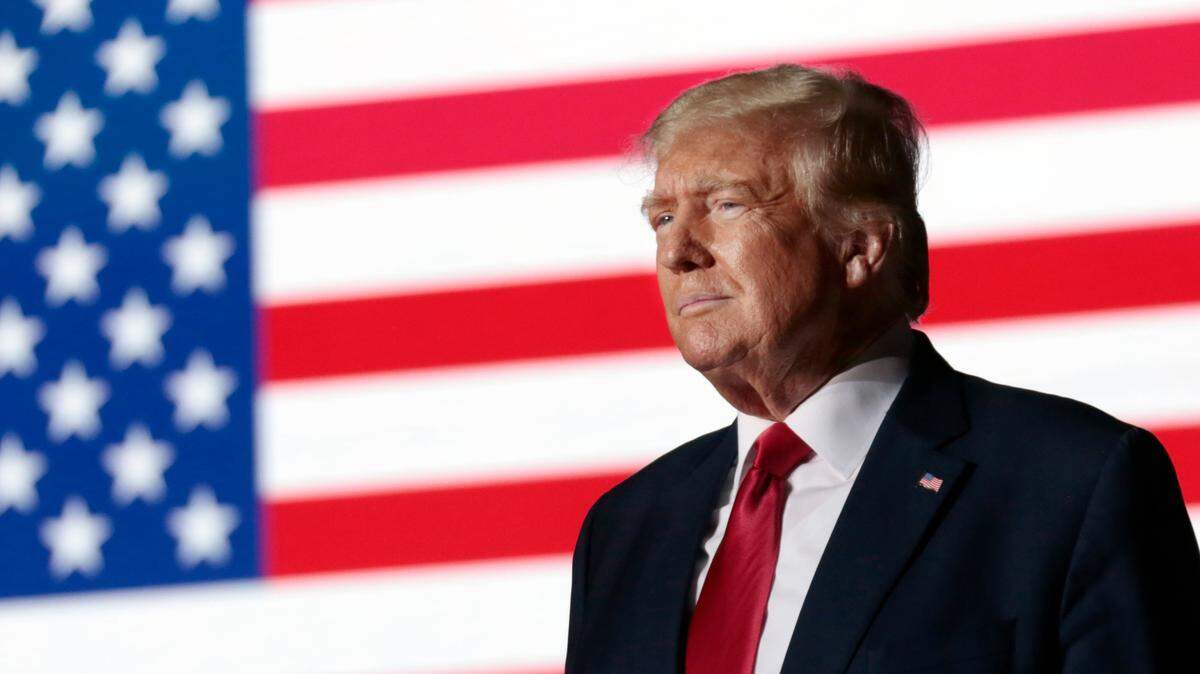 Former President Donald Trump listens to applause from the crowd as he steps up to the podium at a rally in Wilmington, N.C. on Sept. 23, 2022.