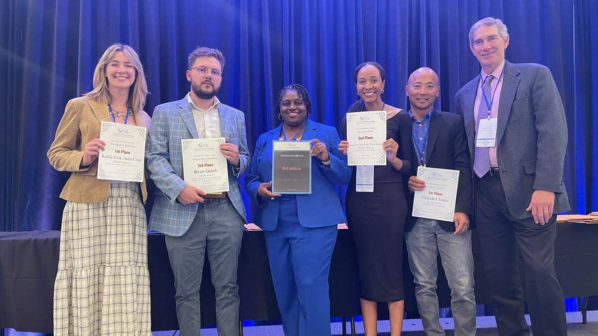 Charlotte Observer staff hold up awards during North Carolina Press Association Awards Banquet, Thursday, Sept. 19, 2024, Sheraton Hotel, Raleigh, N.C. From left: courts reporter Julia Coin; public safety reporter Ryan Oehrli; Executive Editor Rana Cash; service journalism reporter Chyna Blackmon; entertainment reporter Théoden Janes and Managing Editor Taylor Batten.