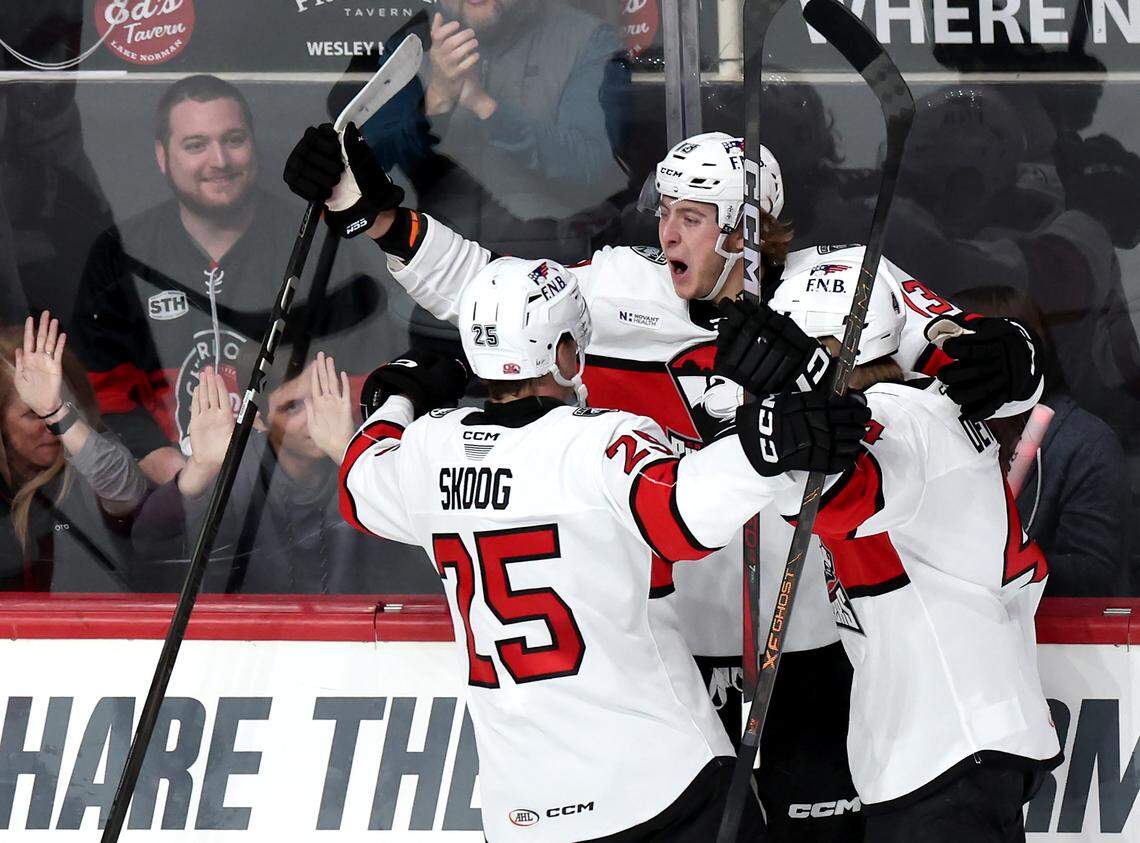 Charlotte Checkers Kai Schwindt, center, celebrates his goal during first period action against the Iowa Wild with his teammates on Friday, October 17, 2025 at Bojangles Coliseum in Charlotte, NC. 