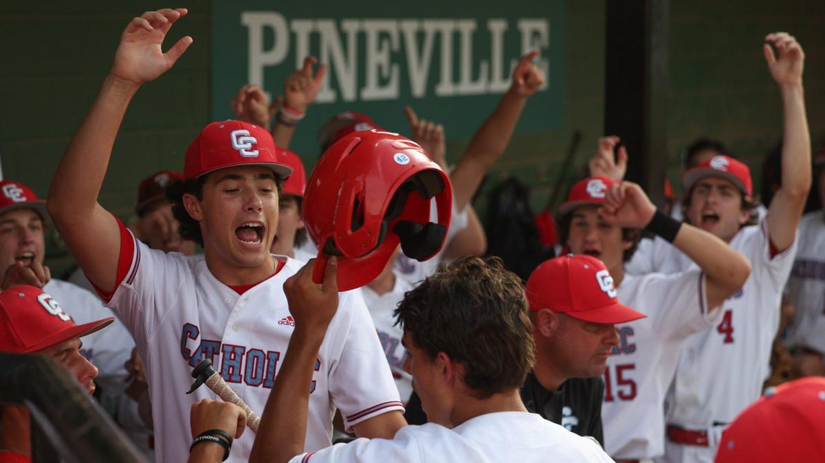 Charlotte Catholic’s John Hucko (6) is greeted by an excited dugout after scoring a run in the bottom of the third inning during the NCHSAA Western Regional championship baseball series against TC Roberson at Jack Hughes Park in Pineville on Thursday, May 23, 2024. Roberson defeated Catholic, 3-1, and advances to the state championship.
