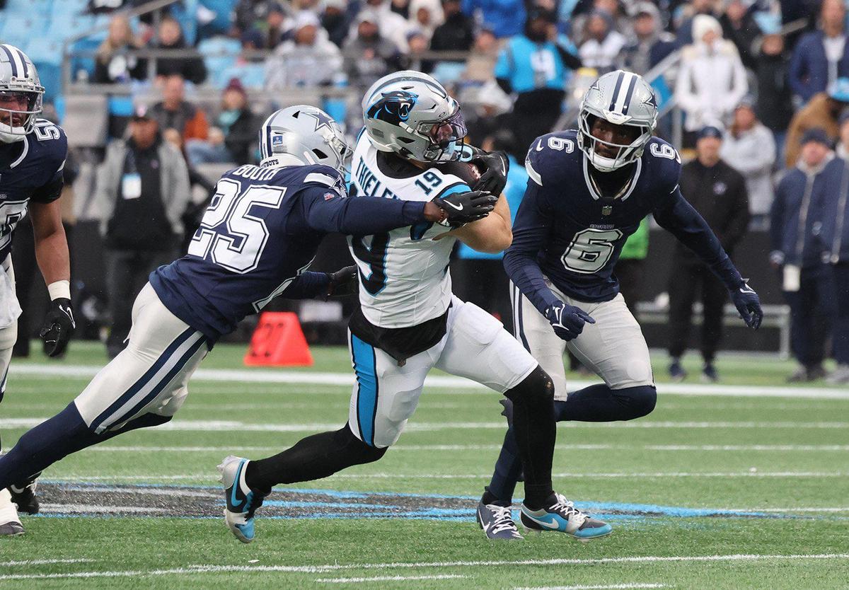 Carolina’s Adam Thielen carries the ball as Dallas’s Andrew Booth tries to make a tackle during the second half of the game against the Dallas Cowboys Sunday in Charlotte.