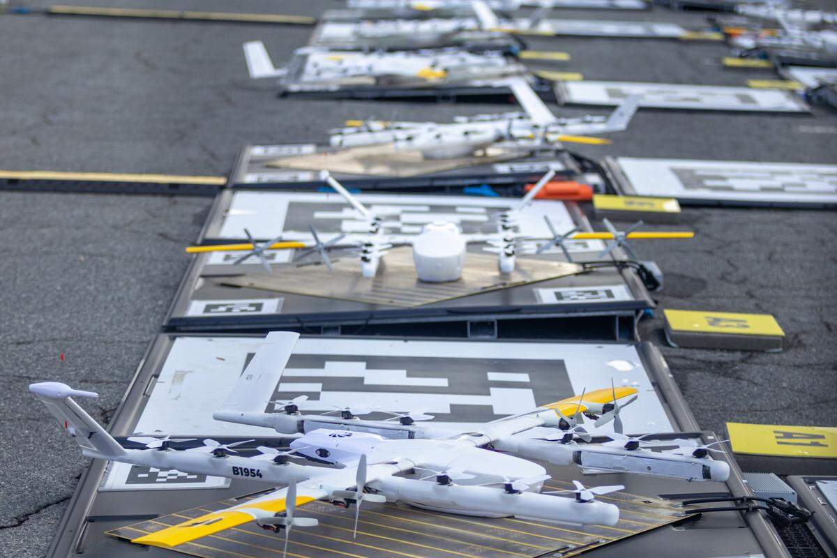 Behind fencing in the Arboretum shopping center’s parking lot is an 18-pad “nest” of Wing delivery drones, where they’ll be stored and charged for DoorDash deliveries.