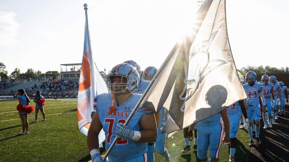 Ballantyne Ridge lineman Farris Ghannam leads the team onto the field before the start of their first game against Fort Mill on Friday, August 23, 2024.