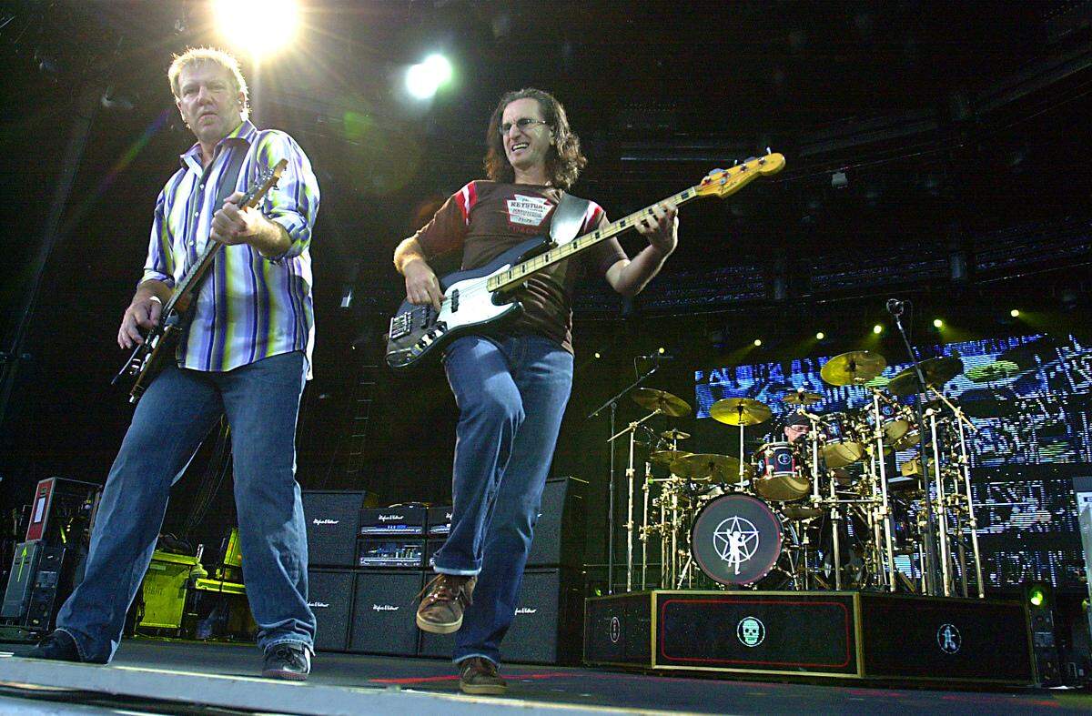 Alex Lifeson, left, Geddy Lee and drummer Neil Peart performed on June 13, 2004, at Verizon Wireless Ampitheater in Bonner Springs, Kansas.
