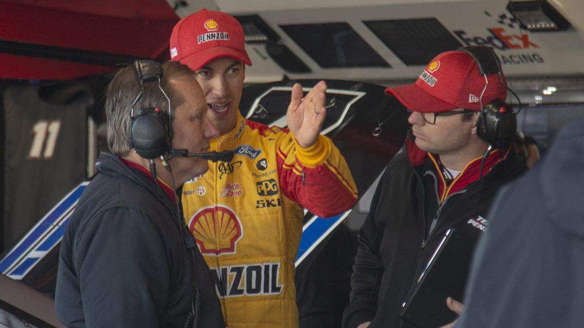 Joey Logano (center) is part of Team Penske, one of two teams that are dominating NASCAR’s Cup Series so far this season.
