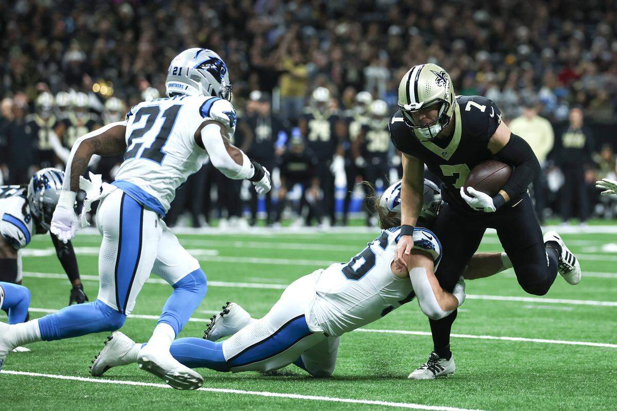 Christian Rozeboom (56) of the Carolina Panthers tackles Taysom Hill (7) of the New Orleans Saints during Sunday’s first half at Caesars Superdome.